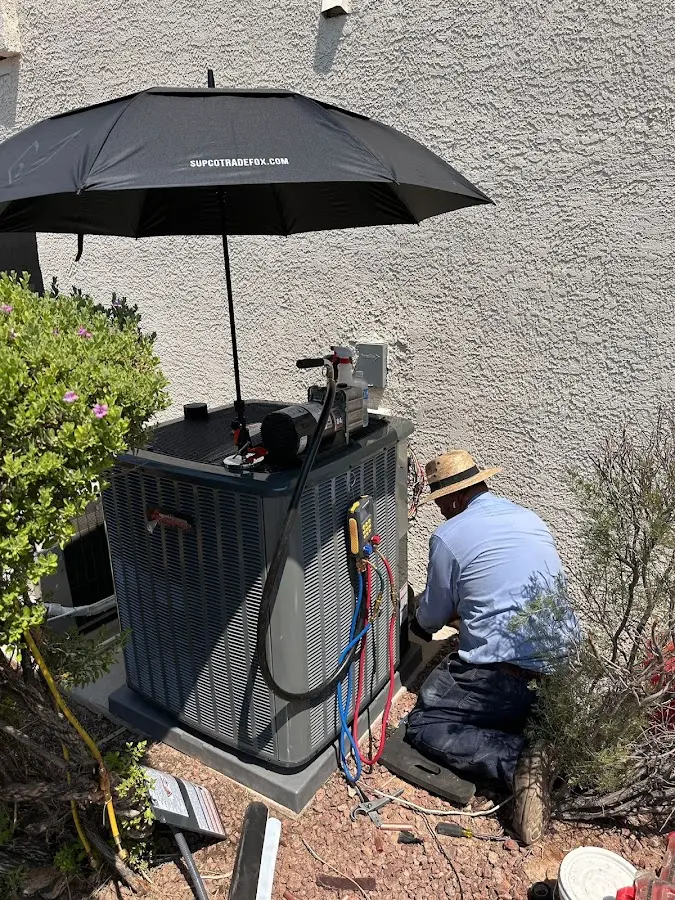 HVAC technician performing outdoor AC maintenance in Lansdowne